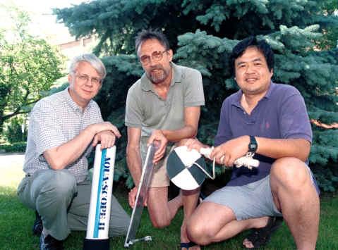 The Secchi Dip-In founders (left to right) holding some of the instruments used in the Dip-In (Viewscope, Turbidity Tube, and Secchi disk): Bob Carlson, Dave Waller and Jay Lee. (Viewscope and turbidity tube courtesy of Lawrence Enterprises)